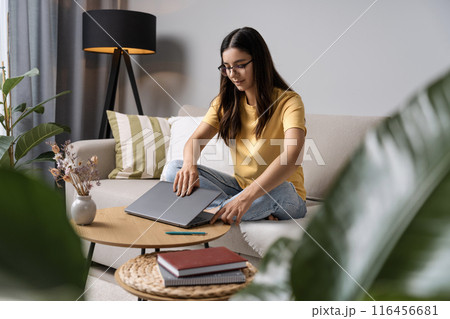 School hustle from home. This young lady is mastering the art of preparing for exams, one click at a time School hustle from home. This young lady is mastering the art of preparing for exams, one click at a time 116456681