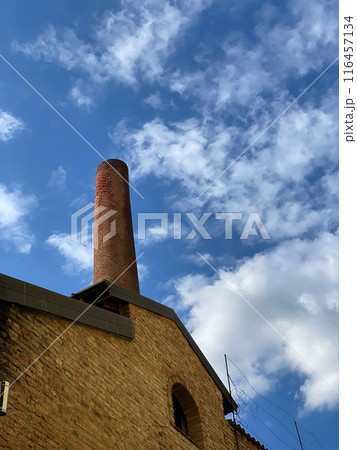 Old brick chimney reaching for the sky 116457134