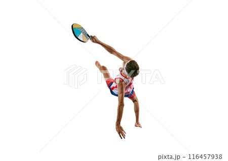 Sportive young man in sportswear, padel tennis player in motion, training, hitting ball with colorful racket isolated on white background Sportive young man in sportswear, padel tennis player in motion, training, hitting ball with colorful racket isolated on white background 116457938