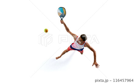 Man in red and blue sports attire playing padel tennis, captured from above as he swings at ball with colorful racket isolated on white background Man in red and blue sports attire playing padel tennis, captured from above as he swings at ball with colorful racket isolated on white background 116457964