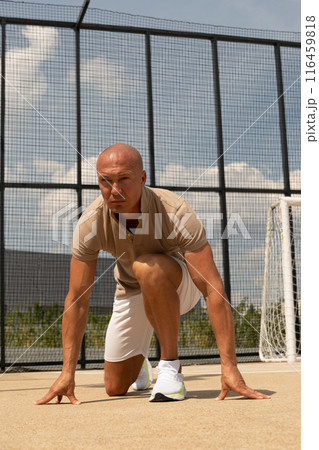 Sports trainer, starts, runner and handsome athlete man on sports ground. Outdoors. Workout open air on urban background. Crossfit training. 116459818