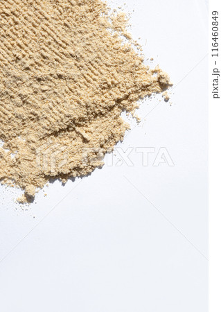 Ground dry ginger root on a white background, place for text 116460849