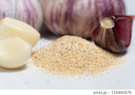 Ground dried garlic powder, natural spice, white background. 116460876