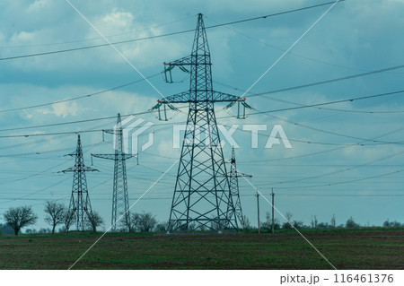 High voltage towers with sky background. Power line support with wires for electricity transmission. High voltage grid tower with wire cable at distribution station. Energy industry, energy saving 116461376