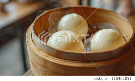 Chinese traditional steamed custard buns close up in bamboo steamer. Chinese traditional steamed custard buns close up in bamboo steamer. 116461851