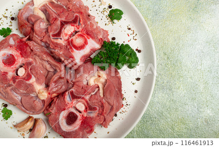 raw steak, calf's neck on the bone, fresh meat, on a white plate, top view, no people, raw steak, calf's neck on the bone, fresh meat, on a white plate, top view, no people, 116461913