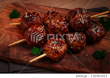 Tsukune, Japanese meatballs, minced chicken, fried on a skewer, with yakitori sauce, homemade,  116461923