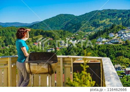 Woman on veranda enjoy norwegian landscape 116462666