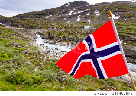 Norwegian flag and camper car in mountains Norwegian flag and camper car in mountains 116462673