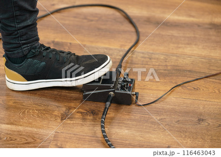 Man using guitar effects pedal Man using guitar effects pedal 116463043