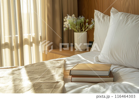 Bedroom with pillows and books with soft sunlight 116464303
