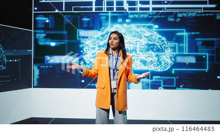 Lively speaker talks at AI event gathering tech startups managers, investors and academics. Expert hosts sessions geared towards helping IT business leaders tap into artificial intelligence, camera B 116464483
