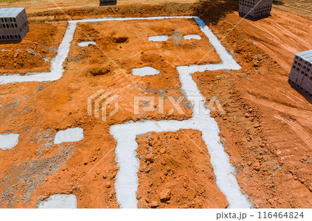 Concrete blocks delivered to construction site with foundation is ready for mounting wall of cement blocks 116464824