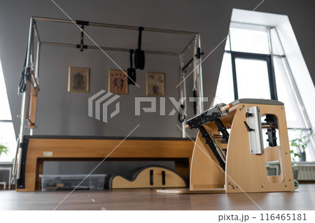 Pilates equipment. Reformer bed. Reformer pilates studio machine for fitness workouts in gym. Fit, healthy and strong authentical body. Fitness concept 116465181