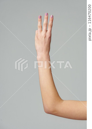 Female hand gesturing numbers on gray background Female hand gesturing numbers on gray background 116470200