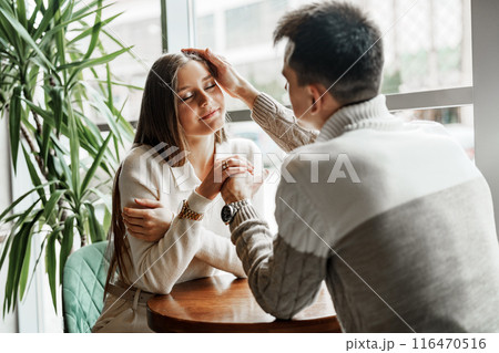 Two Friends Enjoying Casual Conversation Over Coffee at a Modern Cafe During Daytime Two Friends Enjoying Casual Conversation Over Coffee at a Modern Cafe During Daytime 116470516