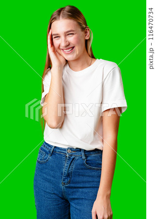 Young Woman Poses for Picture against green background. 116470734
