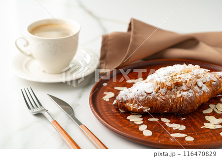 Almond Croissant on clay plate close up 116470829