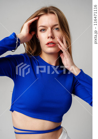 Young Woman model in Blue Top and White Pants posing on white background 116471116