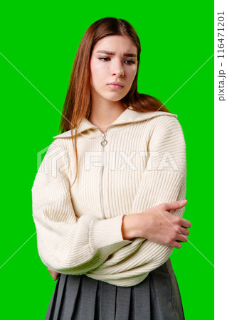 Young Woman Contemplating Deeply Against a Vibrant Green Background Young Woman Contemplating Deeply Against a Vibrant Green Background 116471201