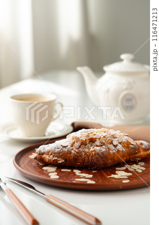 Almond Croissant on clay plate close up Almond Croissant on clay plate close up 116471213