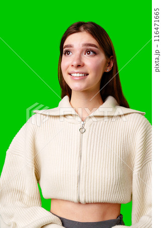 A woman wearing a white sweater is smiling happily. 116471665