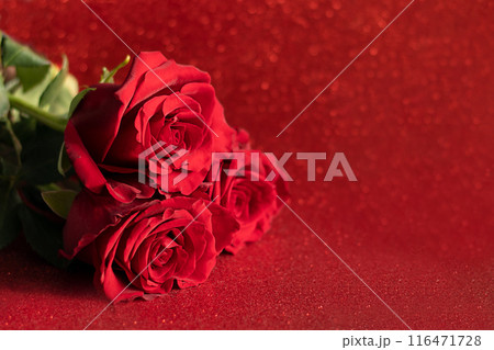Bouquet of red roses on a red romantic background. Valentine's day or wedding background Bouquet of red roses on a red romantic background. Valentine's day or wedding background 116471728