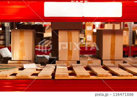 Modern warehouse shelves with pile of cardboard boxes Modern warehouse shelves with pile of cardboard boxes 116471886