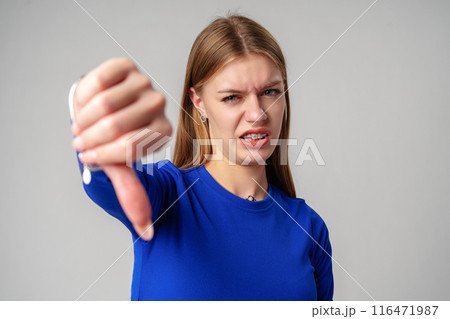 Young Woman Pointing Finger Down at Camera in studio Young Woman Pointing Finger Down at Camera in studio 116471987