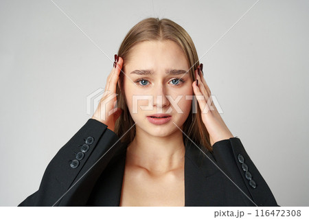 Woman Posing With Hands on Face against gray background 116472308