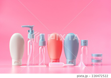 Travel-Sized Bottles of Lotion, Shampoo, and Conditioner on Pink Background 116472522