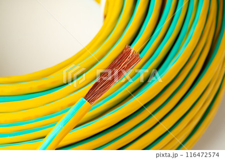 Closeup of Yellow and Green Electrical Wire Spool 116472574