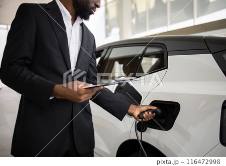 Dealer sells electric SUV in car dealership showroom 116472998