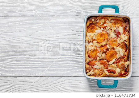 apricot clafoutis, apricot tart in a baking dish 116473734