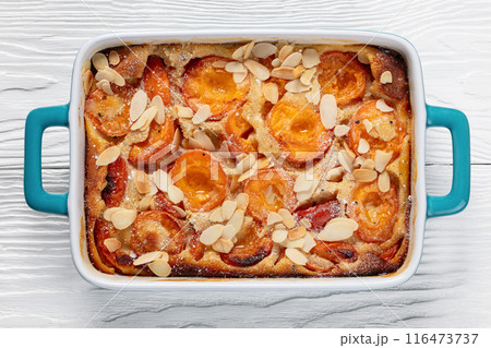 apricot clafoutis, apricot tart in a baking dish 116473737