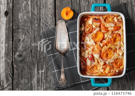 apricot clafoutis, apricot tart in a baking dish 116473746