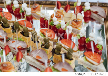 A large selection of various snacks for guests on a mirror surface. Buffet before an important event 116474628