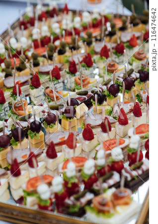 A large selection of various snacks for guests on a mirror surface. Buffet before an important event 116474642