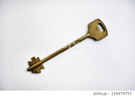 A copper key on a white background. The key to the front door. 116474755