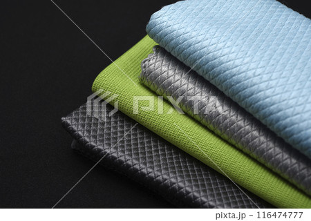 Colorful wiping cloths on a black background. A stack of rags. Cleaning material. 116474777