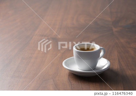 Fresh espresso in a white cup on walnut table with copy space Fresh espresso in a white cup on walnut table with copy space 116476340