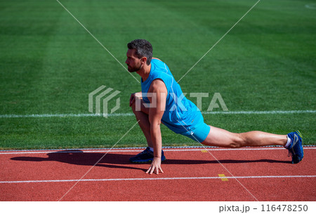 keep moving. sportsman relax. athlete train his flexibility. be flexible. man doing stretching exercise on stadium. fitness gym outdoor. muscular athletic guy training. sport. male stretch muscles 116478250