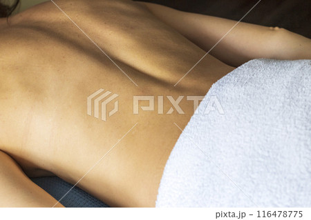 Shot of the young female relaxing after massage in the spa. 116478775