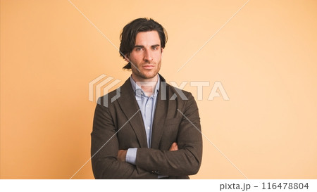 Disagreeing adult businessman shaking head in brown studio 116478804