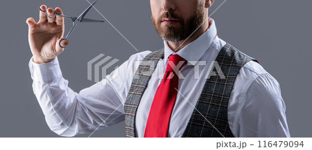 unshaven man hairdressing with professional scissors isolated on grey background. man cut hair unshaven man hairdressing with professional scissors isolated on grey background. man cut hair 116479094
