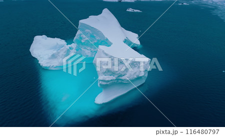 Antarctica melting blue iceberg drifting ocean water. Glacier arch hole in melted ice. Environment ecological issue of global warming, climate change. Cinematic aerial drone panorama 116480797