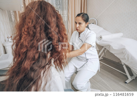 delicate interaction between a healthcare professional and a patient during a routine examination delicate interaction between a healthcare professional and a patient during a routine examination 116481659