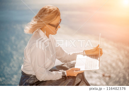 Business woman on nature in white shirt and black skirt. She wor 116482376