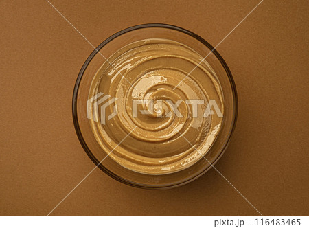 Peanut butter swirl in glass bowl, top view with copy space Peanut butter swirl in glass bowl, top view with copy space 116483465