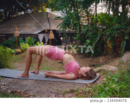 Beautiful woman practices yoga in Crabi, Thailand Beautiful woman practices yoga in Crabi, Thailand 116484078